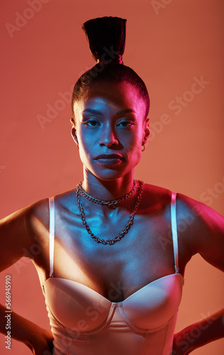 Portrait, neon and style with a model black woman in studio on a kaleidoscope background for beauty. Art, makeup and fashion with an attractive young female posing indoor for culture or cosmetics