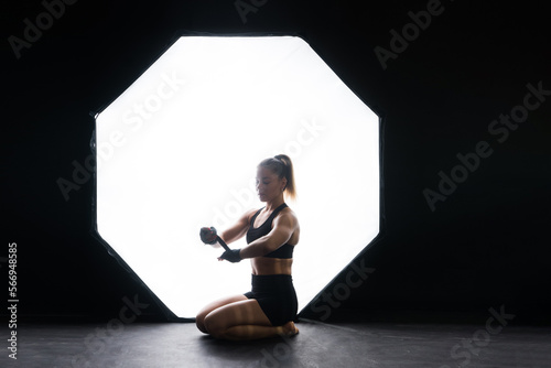 Woman Boxer In Gloves Training On black, red, yellow Background