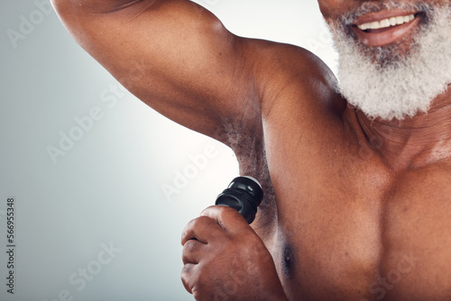 Studio, black man and armpit with deodorant, smile and body care and grooming space isolated on grey background. Skincare, health and happy senior male with skin product for cleaning and wellness.