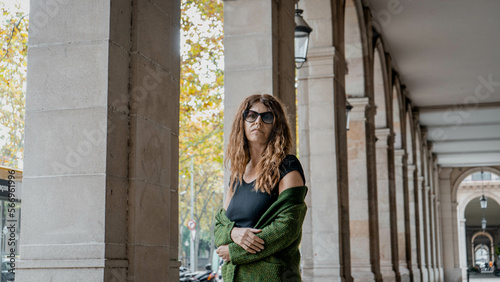 young woman with a green jacket in an urban environment