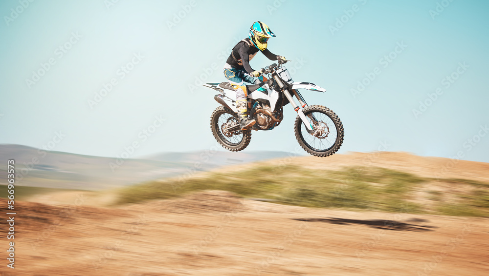 Motorcycle, offroad driving and air jump in desert, blue sky and freedom. Driver, cycling and power stunt on dirt track, competition and motorbike performance on adventure course for fast action show Motorcycle, offroad driving and air jump in desert, blue sky and freedom. Driver, cycling and power stunt on dirt track, competition and motorbike performance on adventure course for fast action show