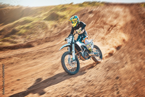 Sport, motorcycle and person driving in a desert for fitness, training and extreme sports in nature. Biking, motorbike and athletic practice stunt, speed and adrenaline in sand, exercise and freedom