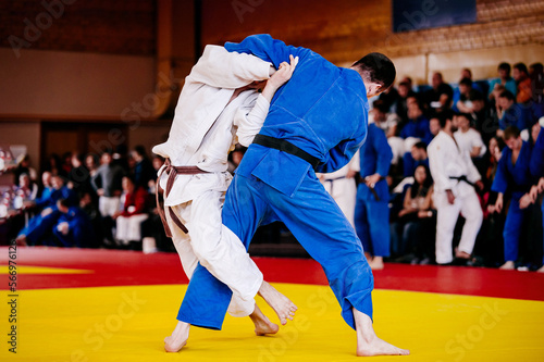 judo fighters on tatami fight in judo competition