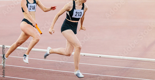 women relay race running track and field competition