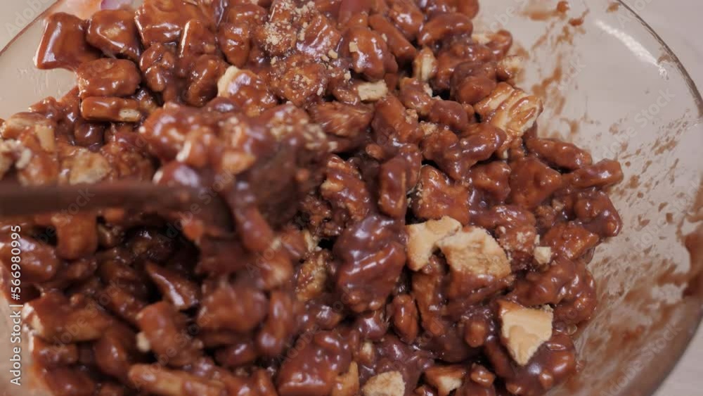 Mixing cookies with melted chocolate, close up. Mixing cookies with melted chocolate, close up.