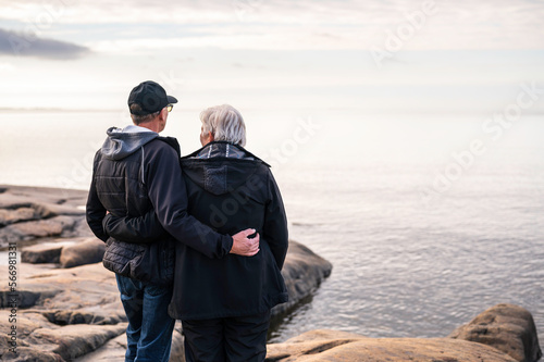 Elderly couple standing on a rocky beach. Fäboda, Jakobstad/Pietarsaari, Finland.