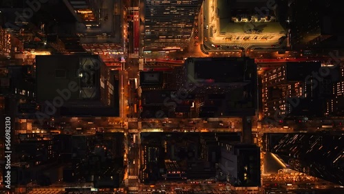 Aerial shot of generic North American featureless urban area. 4k night drone shot of the busy downtown streets