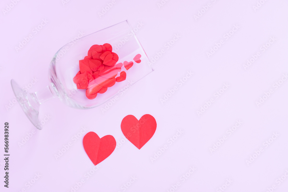 Wine glass with Red paper hearts shape on pink background, Happy Valentine's day	