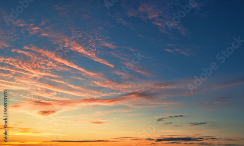 The sky before dawn, orange clouds on the background of the blue sky. © maykal