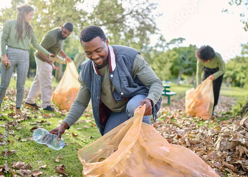 Trash, community volunteer or man cleaning garbage pollution, waste product or African environment support. Plastic bottle container, NGO charity or eco friendly people help with nature park clean up