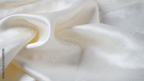 White silk fabric - soft, and delicate with shine, folds, creases. Smooth elegant silk background