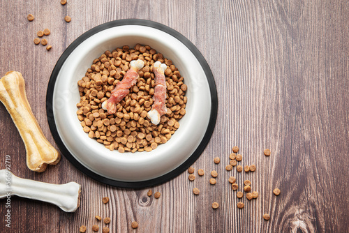 A bowl of dog food on a wooden floor.