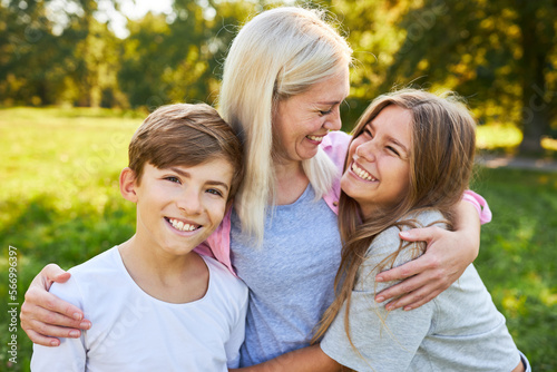 Happy mother hugs her two children