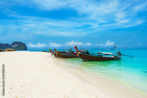 Thai traditional wooden longtail boat and beautiful sand beach in Thailand. Traveling concept.