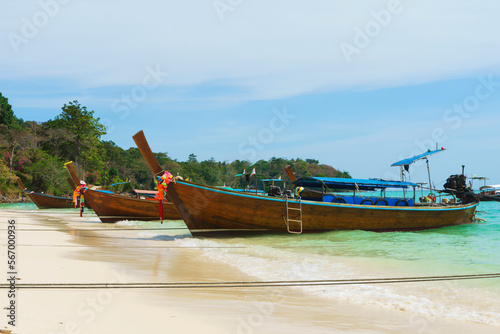 Thai traditional wooden longtail boat and beautiful sand beach in Thailand. Traveling concept. © Acronym