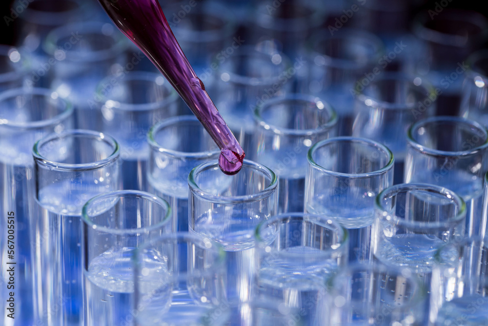 Pipette dropping fluid into test tube