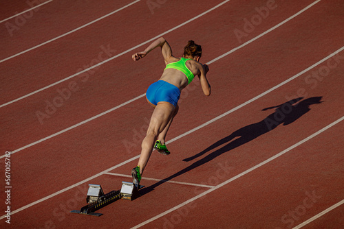 female athlete start running 400 meters in stadium