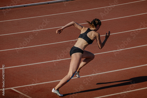 female athlete beginning running 400 meters at stadium
