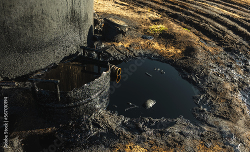 Fresh black oil spilling to ground , environment concept photo