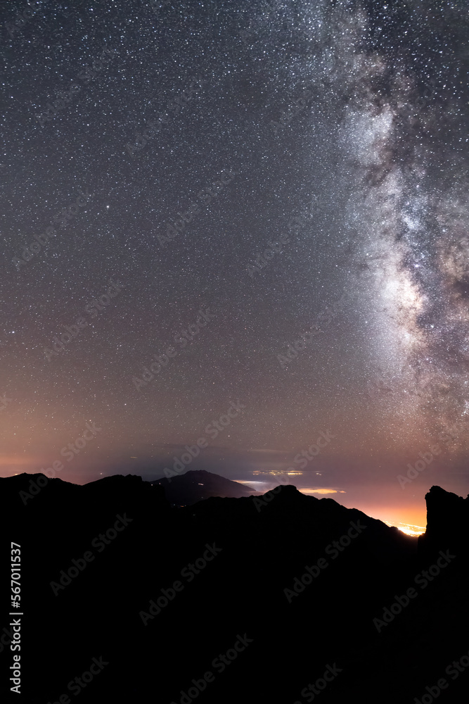 Milky way over the El Paso city and mountain silhouette