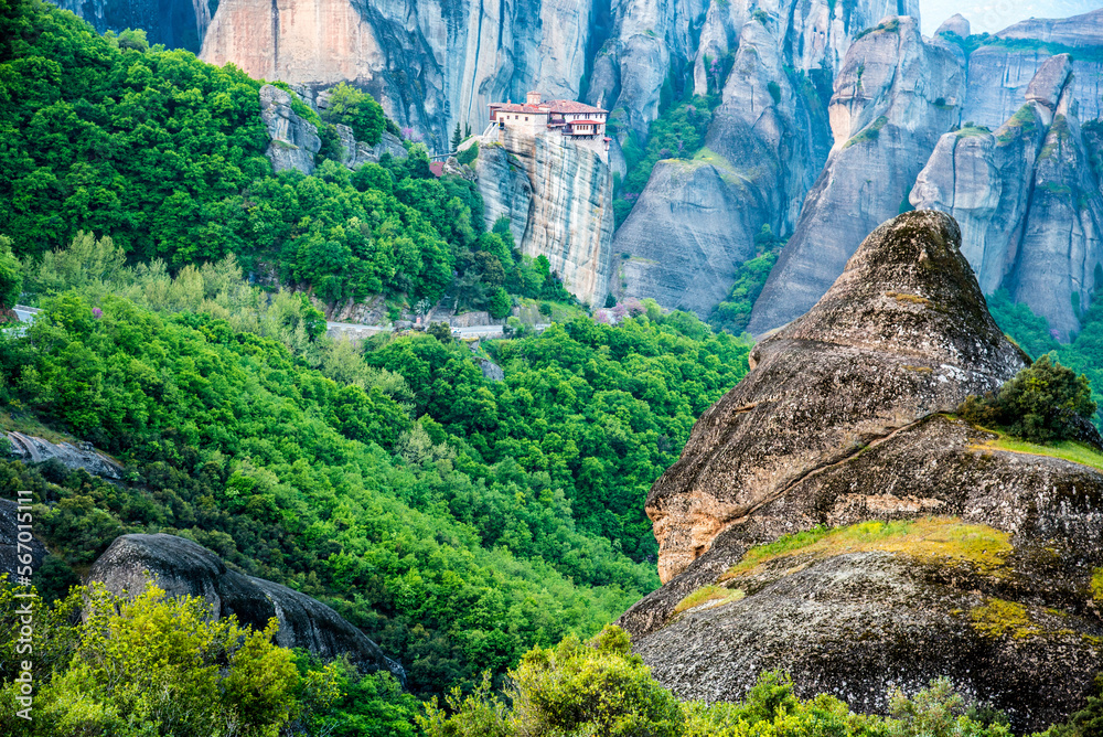 A magical view with the spire of the hill in the holy complex in the famous valley of the Meteora rocks in Greece. Great amazing world. Attractions.