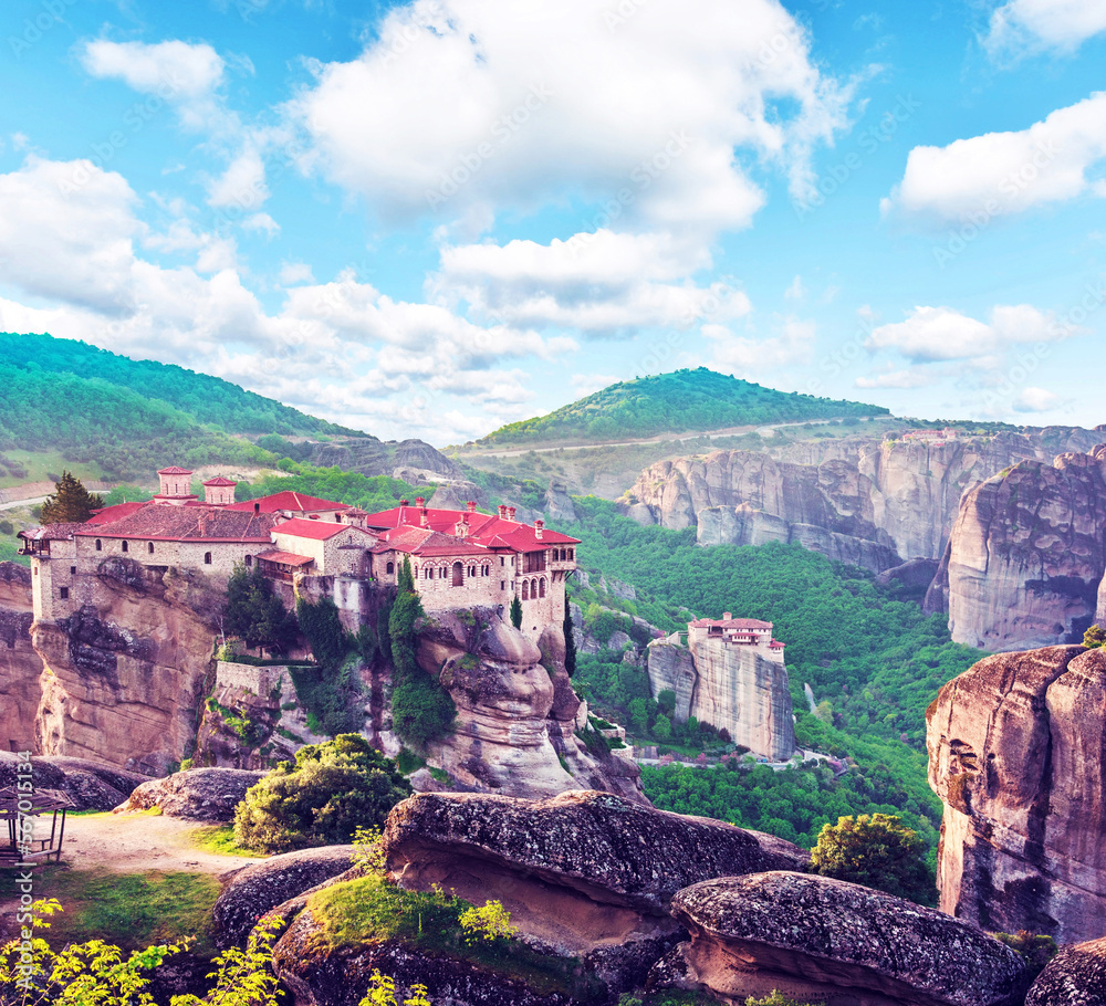 A magical view with the spire of the hill in the holy complex in the famous valley of the Meteora rocks with Eastern Orthodox Monastery of Varlaam in Greece. Great amazing world.