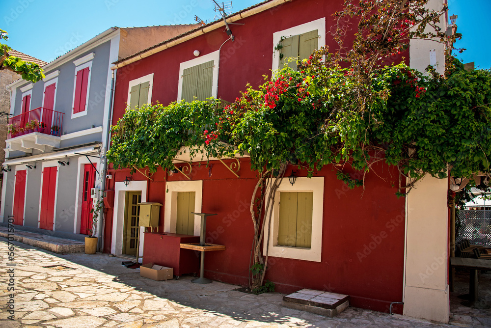 Beautiful atmospheric street view facade with flower pots in the port town of Fiskardo, Kefalonia, Greece. Stunning amazing charming places. prominent tourist towns.