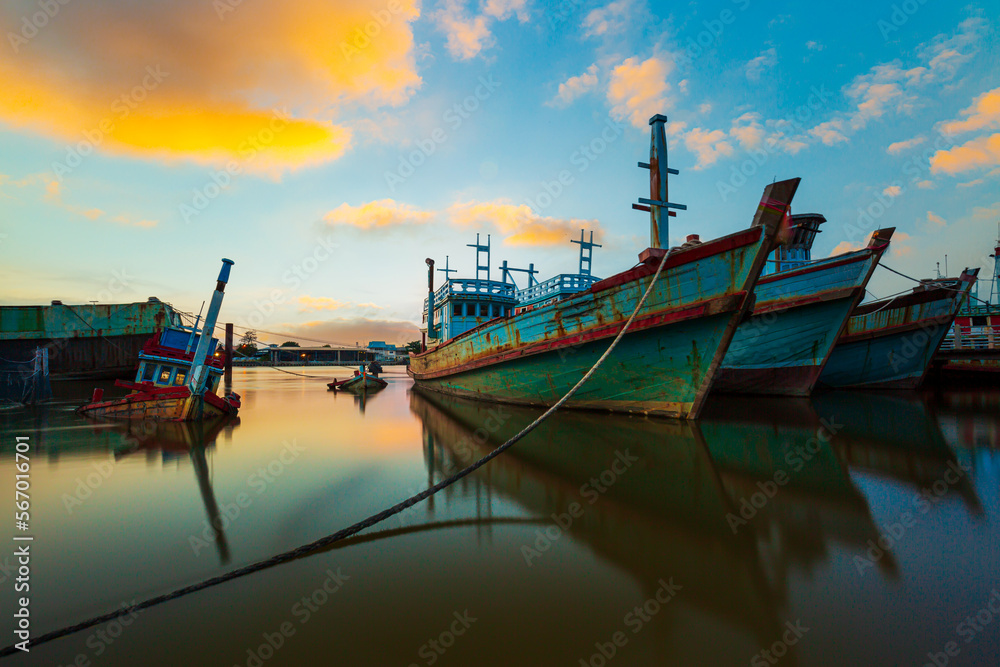 Fishing boats and evening sky,Picture of a fishing boat facing a high oil crisis at sunrise, Thailand