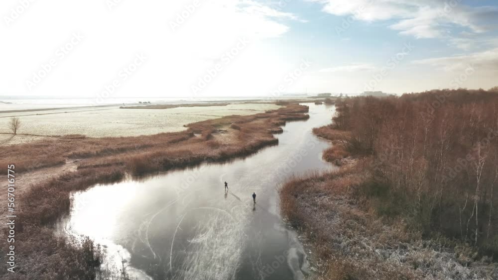 Ice skating on the Drontermeer lake in nature seen from above during a cold winter day in The Netherlands. Ice skating on the Drontermeer lake in nature seen from above during a cold winter day in The Netherlands.