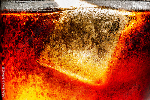 macro cola,Close-up of a glass of cola with ice cubes and bubbles ,Drinking Glass,Soda,Brown,Bubble,Caffeine,Carbonated,
