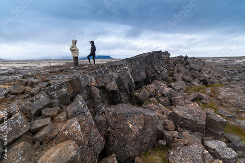 Surtshellir lava cave - In the Iceland couple stands on the rocks