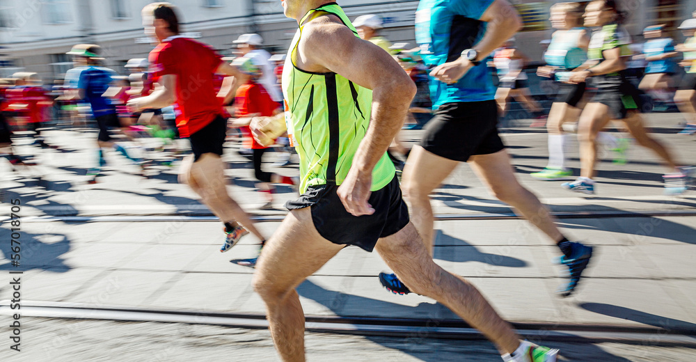 group athletes runners running marathon motion blur