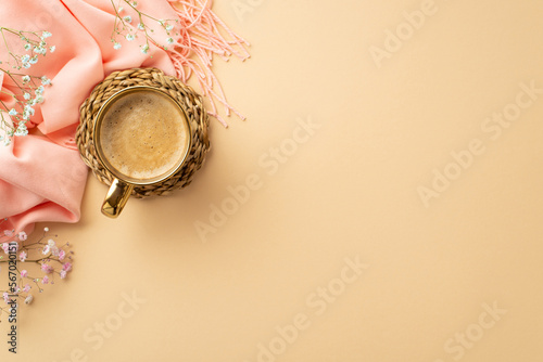 Hello spring concept. Top view photo of cup of fresh coffee on rattan serving mat pink soft plaid and gypsophila flowers on isolated pastel beige background with blank space