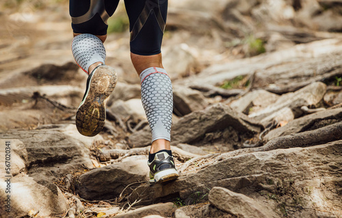 legs male runner in compression socks run over rocks photo