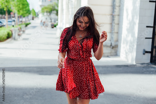 a woman in a red dress on the street © dmitriisimakov