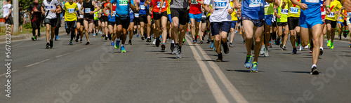 large group of leg runners athletes run urban marathon
