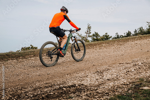 male athlete on mountain bike riding cross country race