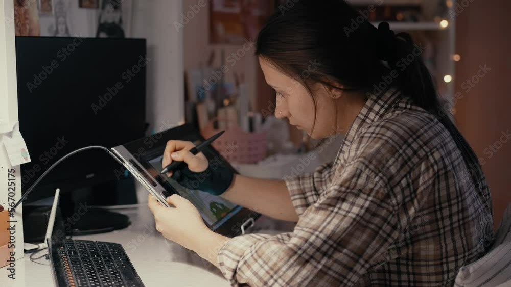 Woman drawing on graphics tablet Woman drawing on graphics tablet