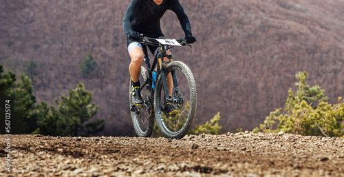 male cyclist biking mountain bike on trail race