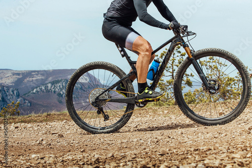 male athlete on mountainbike riding mountain trail
