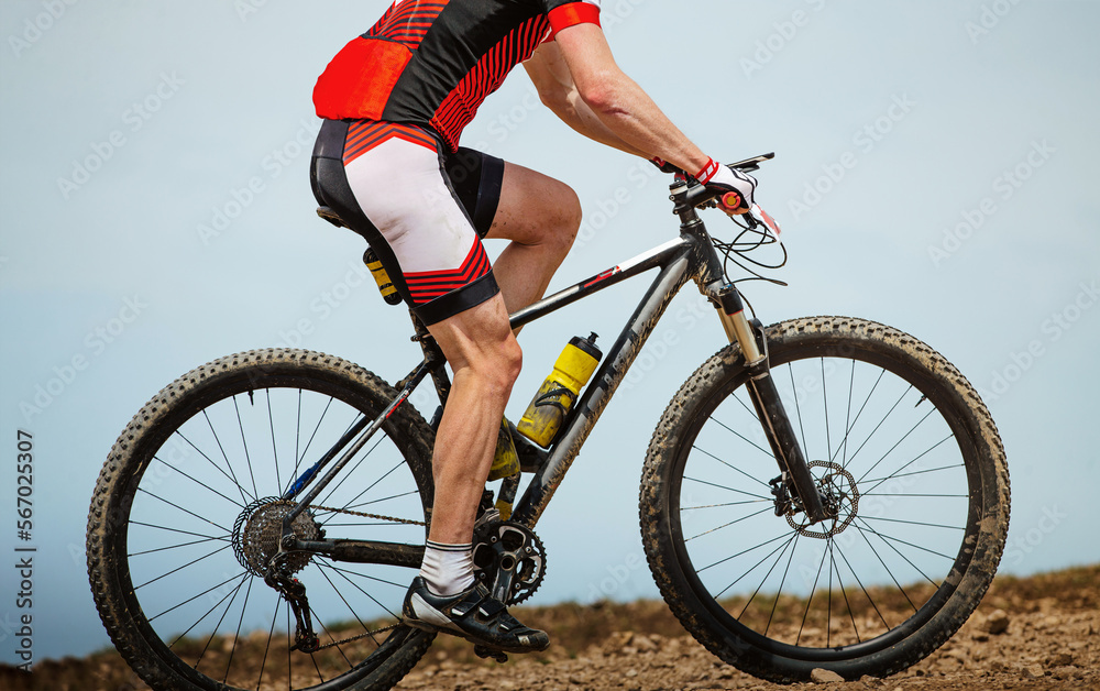 close-up male athlete mountain biker in background sky close-up male athlete mountain biker in background sky