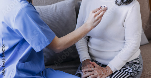 Homecare nursing service and elderly people cardiology healthcare. Close up of young hispanic female doctor nurse check mature caucasian man patient heartbeat using stethoscope during visit © ARMMY PICCA