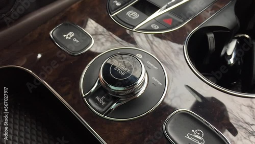 Bentley Bentayga hybrid pushing the start stop engine button photo