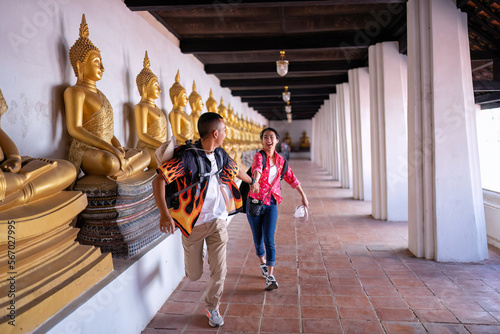 Traveler tourist man and women with backpack walking in historical place temple Ayuttaya Thailand photo