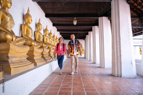 Traveler tourist man and women with backpack walking in historical place temple Ayuttaya Thailand