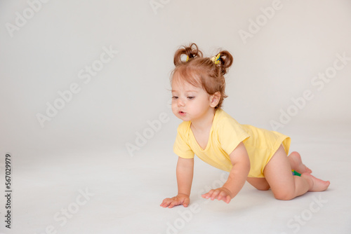 baby girl starting to walk crawling on a white background