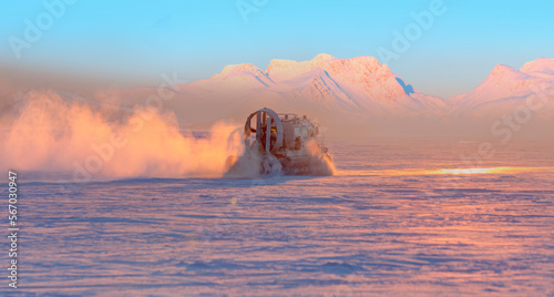 Hovercraft rides on Lake Baikal ice at sunset