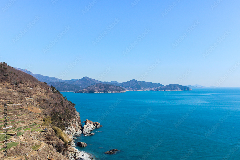 Panoramic view of island and sea under blue sky.