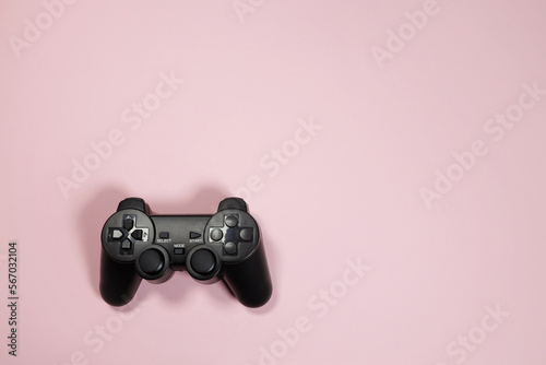Wireless modern joystick gamepad on pink background, minimalism style. Copyspace for text