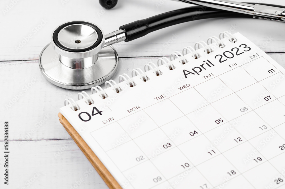 The April 2023 deskcalendar and medical stethoscope medical on wooden background, schedule to check up healthy concepts. The April 2023 deskcalendar and medical stethoscope medical on wooden background, schedule to check up healthy concepts.